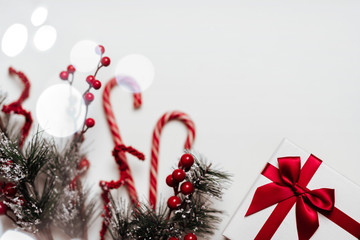 Wall Mural - Christmas background with Christmas gift, fir branches, pine cones, snowflakes, red decorations. Xmas and Happy New Year composition. Place for text. Flat lay, top view