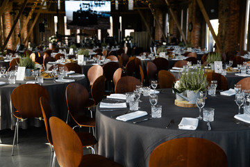 Food served on round table in a white hall during a Birthday corporate party in Eastern European Baltic Riga Latvia - Wooden ambar hall in countryside style - Canape, snacks and light drinks