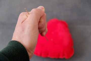 Wall Mural - red pincushion and a large sewing needle, needle spell,