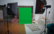 © Adil - The chroma key. Real empty green screen Chroma key film photo studio with lighting studio equipment . green screen chroma key background on commercial set .