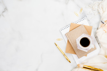 Wall Mural - Feminine home office desk table with fashion accessories and office supplies. Flat lay, top view, copy space. White marble background with stylish scarf, paper notebook, cup of coffee, golden pen.