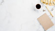 © photoguns - White marble desktop with golden office accessories and stationery. Home office desk table with gold tropical monstera leaf, cup of coffee, paper notebook, pen. Flat lay style minimal layout. Top view