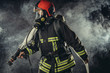 © alfa27 - emergency situation. brave fireman came to protect and save from fire after emergency call, professional fireman worker in smoke