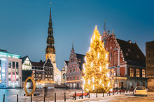 Riga, Latvia. Town Hall Square, Popular Place With Famous Landmarks On It In Bright Evening Illumination In Winter Twilight. Winter New Year Christmas Holiday Season