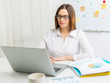 © Oleksandr - Young business woman works at a computer.
