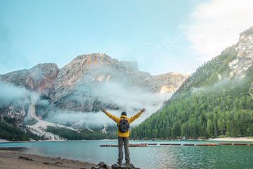 Wall Mural - young tourist hiker man at beautiful alpine lake lago di braies (pragser wildsee) in trentino. raisi