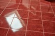 © Gudellaphoto - Shiny blue tiled bathroom floor reflecting light