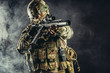 © alfa27 - young soldier of russian military forces stand in smoky foggy space holding gun rifle, wearing green uniform, helmet and using special equipment