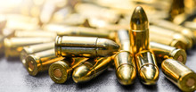 Bullets Ammunition On Stone Table Wide Banner Or Panorama. Bullet Pile Background Copy Space.  Magazines, Rounds And Ammo Military Technology.