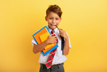 Child Cries Because He Has A Lot Of School Homework. Emotional Expression. Yellow Background