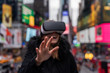 © NDStock - young woman using VR in the city of new york