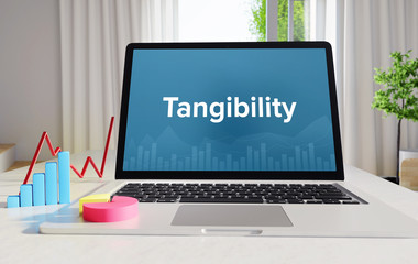 Tangibility – Statistics/Business. Laptop in the office with term on the Screen. Finance/Economy.