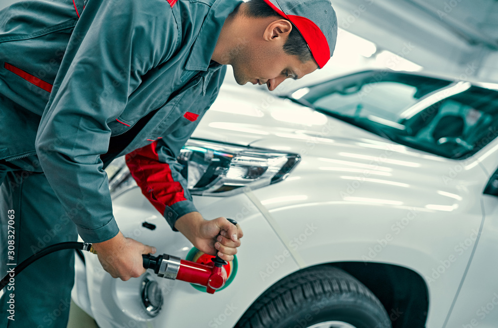 Auto mechanic buffing car autobody. Car repair and maintenance. Stock ...