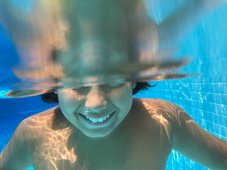 Wall Mural - Boy enjoying in pool underwater