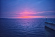 © SUNGYOON - the horizon of a calm sea with a beautiful red sunset.