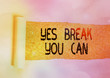 Conceptual hand writing showing Yes break You Can. Concept meaning Positivity Encouragement Persuade Dare Confidence Uphold Cardboard which is torn placed above a wooden classic table