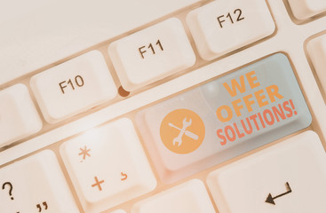 Conceptual hand writing showing We Offer Solutions. Concept meaning way to solve problem or deal with difficult situation White pc keyboard with note paper above the white background