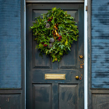 Christmas Wreath On A Weathered Door With Shutters