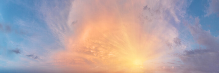 Wall Mural - sunset cloudy sky with the orange sun