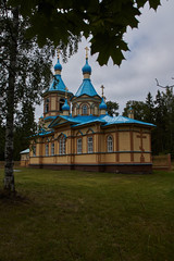 An ancient Orthodox monastery, in which monks used to live in solitude. Located on the shore of Lake Ladoga, Valaam Island. The building is stone, surrounded by a fence. Russia, Karelia