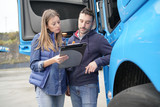 Fototapeta  - Logistics manager controlling truck driver schedule
