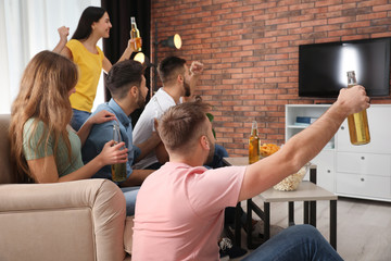 Wall Mural - Group of friends watching football at home