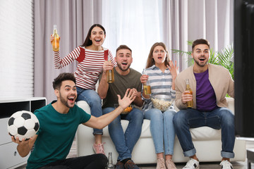 Wall Mural - Group of friends watching football at home