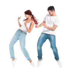 Beautiful young couple dancing on white background