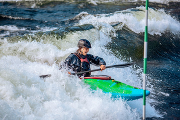 Wall Mural - Whitewater kayaking, extreme sport rafting. Guy in kayak sails mountain river