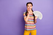 © deagreez - Photo of beautiful lady holding bucks rich young girl freelancer not believe big salary hand on cheek wear striped t-shirt yellow trousers isolated purple color background