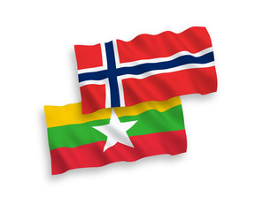 National vector fabric wave flags of Norway and Myanmar isolated on white background. 1 to 2 proportion.