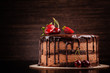 © zukamilov - Chocolate cake with with berries, strawberries and cherries. cake on a dark brown background. copy space