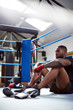 © Monkey Business - Tired Male Boxer Sitting In Boxing Ring In Gym After Training Session
