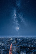 © Jamo Images - A city at night with an epic milky way on the sky