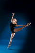 © alenaslostina - girl dancer in a jump and a beautiful pose on a blue background
