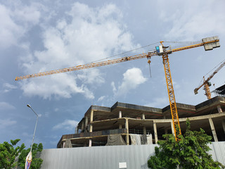 Tower crane in construction site against cloud and blue sky at BANGKOK, THAILAND.