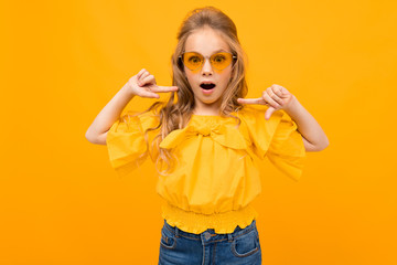 Wall Mural - Nice little girl with her glasses smiles isolated on white background