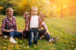 © klepach - Little cute son playing with parents in forest
