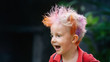 © Tropical studio - Funny portrait of boy with messy hairstyle. Crazy hipster kid. Stylish boy with painted colorful hair. Happy children having fun and celebrating at party in family summer camp. positive and cheerful.