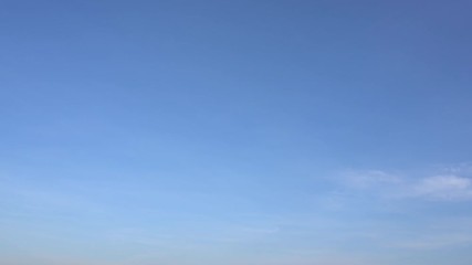 Wall Mural - time lapse of peaceful sunny blue sky with soft white clouds running along. plane flying at end of c