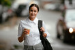 © JustLife - Young businesswoman drinking coffee. Beautiful student walking around the city..