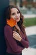 © primipil - Portrait of a young positive woman with autumn yellow leaf