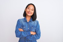 Young Beautiful Chinese Woman Wearing Denim Shirt Standing Over Isolated White Background Happy Face Smiling With Crossed Arms Looking At The Camera. Positive Person.