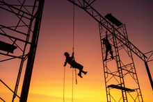 Male Working Abseiling On A Construction Site Silhouette Worker