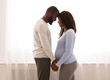 © Prostock-studio - Black pregnant couple bonding at home, happy together