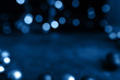 Main color trend 2020 classic blue pantone. Abstract bokeh texture lights on a dark background with copy space. Sparkling lights product background. Bokeh background of garland lights.