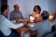 © Krakenimages.com - Family and friends dining at home celebrating christmas eve with traditional food and decoration, all sitting on the table together