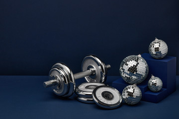 Wall Mural - Dumbbell and mirror balls. Fitness New Year and Christmas background