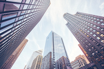 Looking up at Chicago skyscrapers, color toning applied, USA.