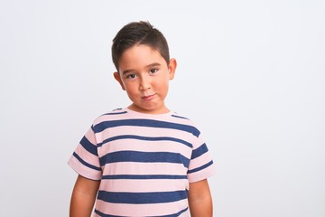 Sticker - Beautiful kid boy wearing casual striped t-shirt standing over isolated white background depressed and worry for distress, crying angry and afraid. Sad expression.